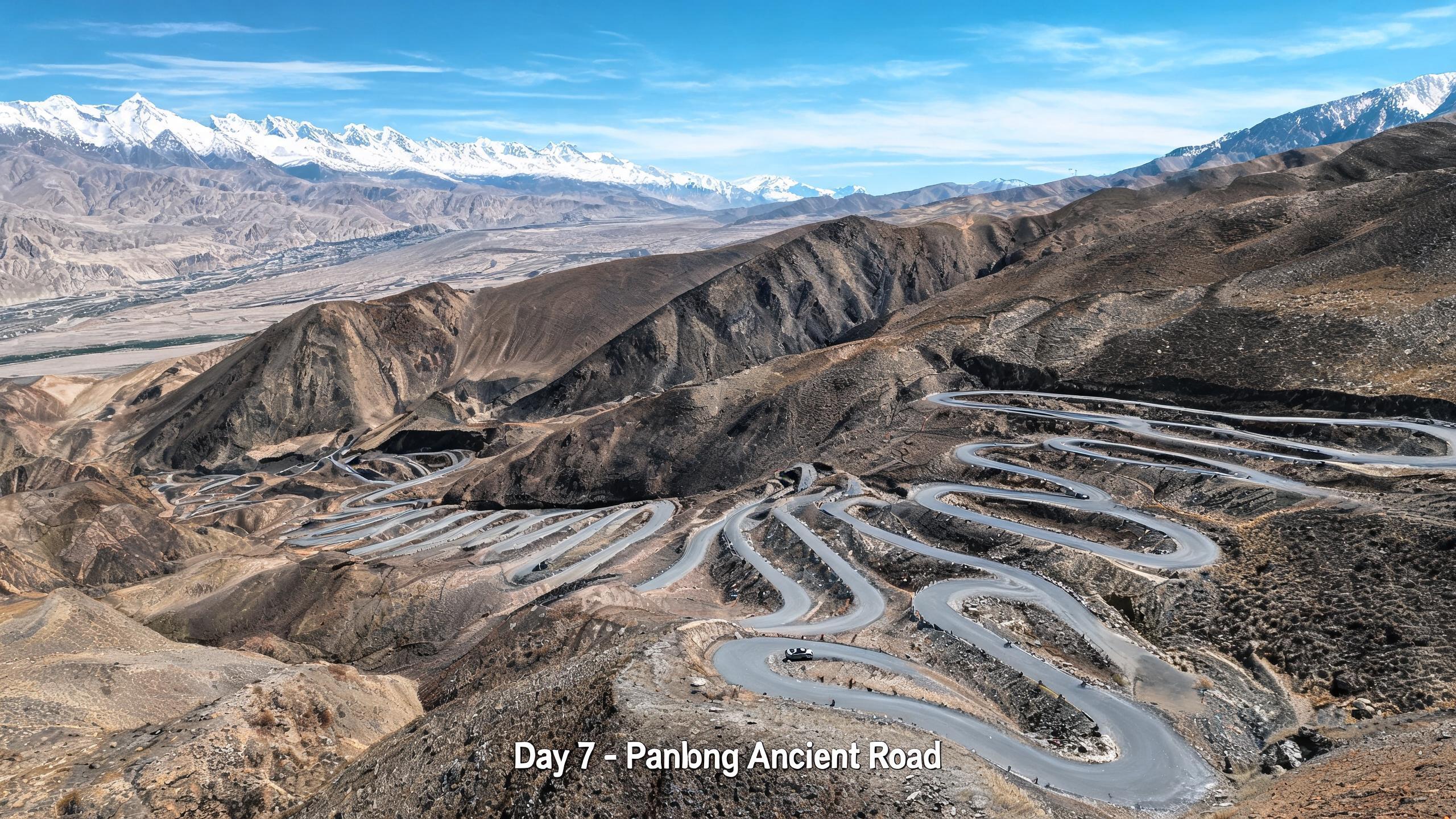 盘龙古道盘山公路,600多道弯蜿蜒盘旋在山间,远处是雪山
